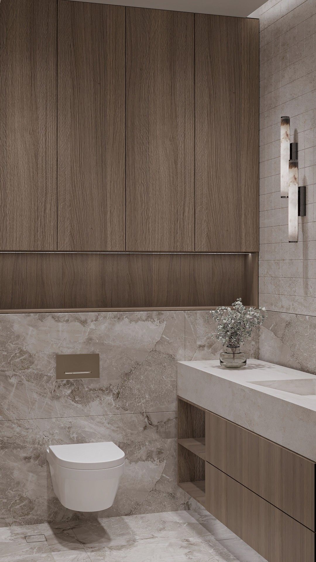 The bathroom toward the WC — tall timber cabinets with a lit niche above a veined stone wall, the vanity at right.